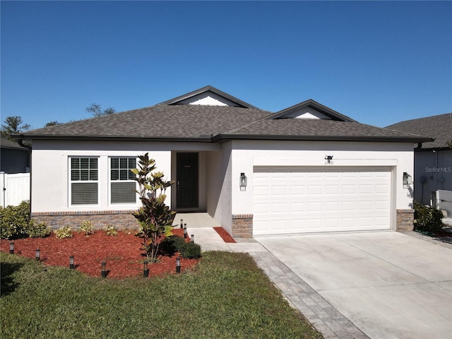 single story home featuring a garage and a front lawn