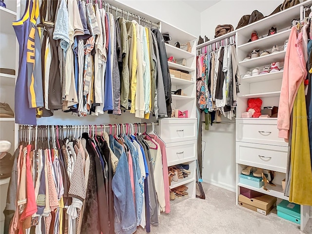 walk in closet featuring light colored carpet