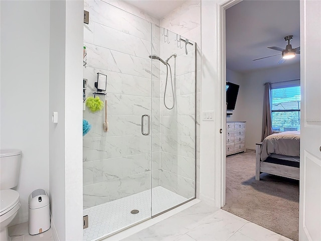 bathroom with a shower with shower door, ceiling fan, and toilet