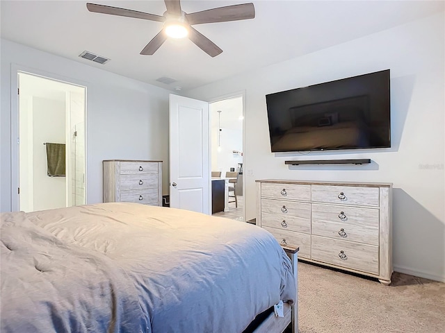 carpeted bedroom featuring ceiling fan and ensuite bathroom