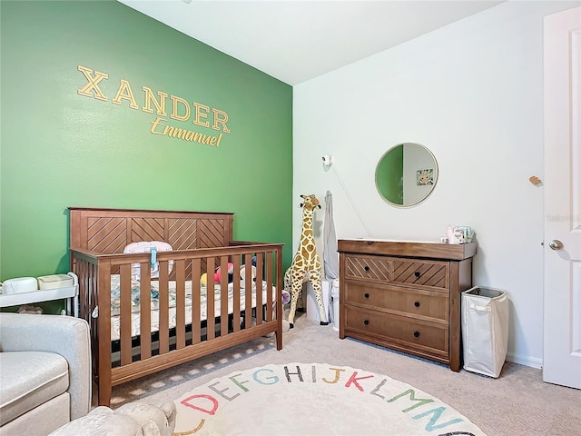 carpeted bedroom with a nursery area