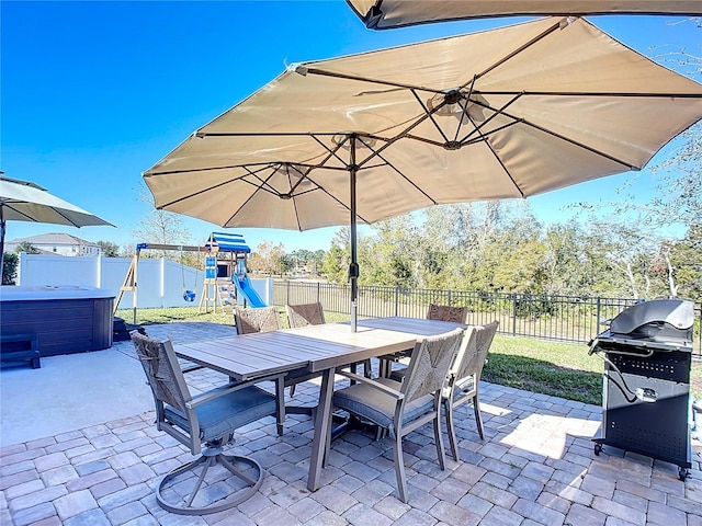 view of patio / terrace with grilling area and a playground