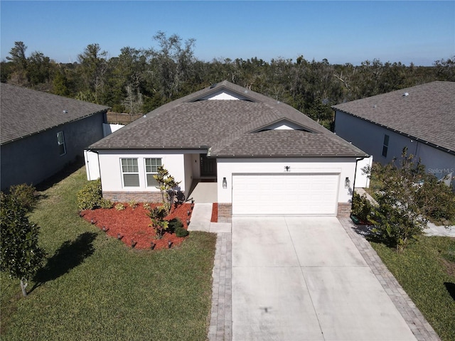 ranch-style house featuring a front lawn, roof with shingles, stucco siding, a garage, and driveway