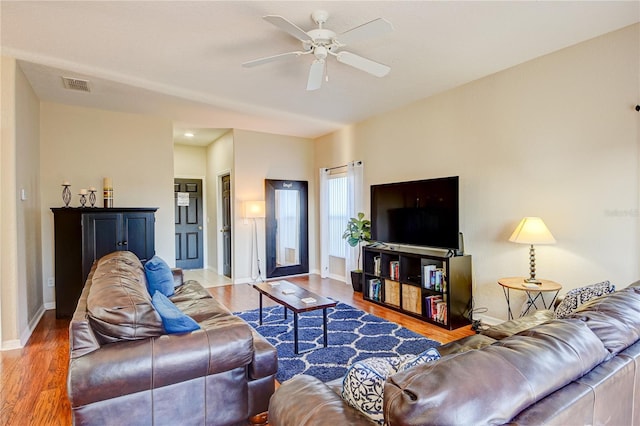 living room with ceiling fan and wood-type flooring