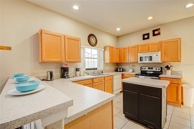 kitchen featuring light brown cabinetry, sink, white appliances, and light tile patterned floors