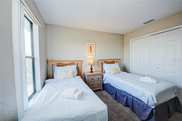 carpeted bedroom with a closet