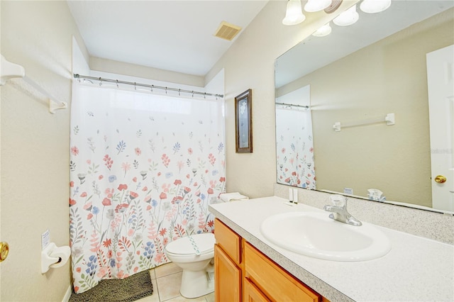 bathroom with toilet, vanity, a shower with curtain, and tile patterned floors