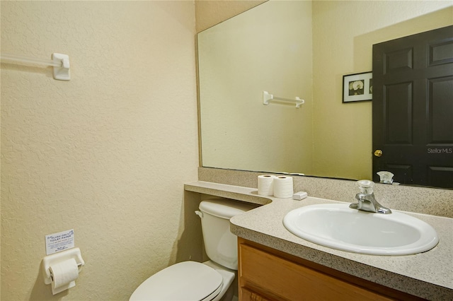 bathroom with toilet and vanity