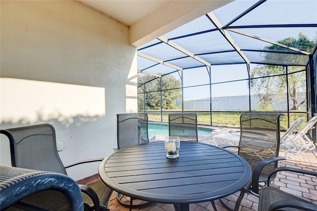 view of patio with glass enclosure