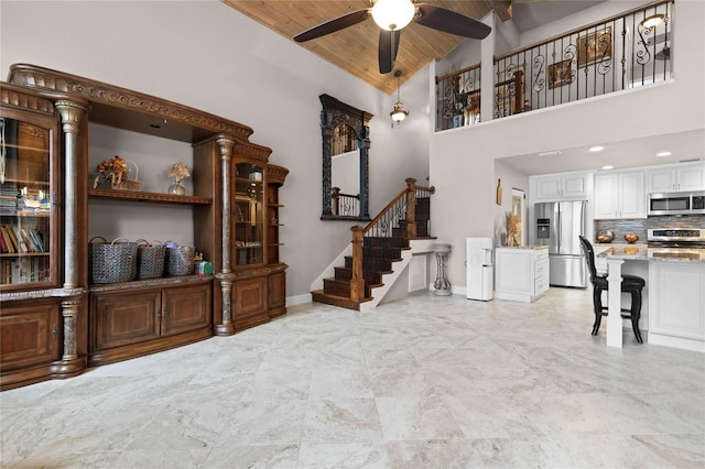 living room with high vaulted ceiling, ceiling fan, and wood ceiling