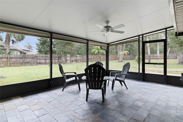 sunroom / solarium with ceiling fan and a healthy amount of sunlight