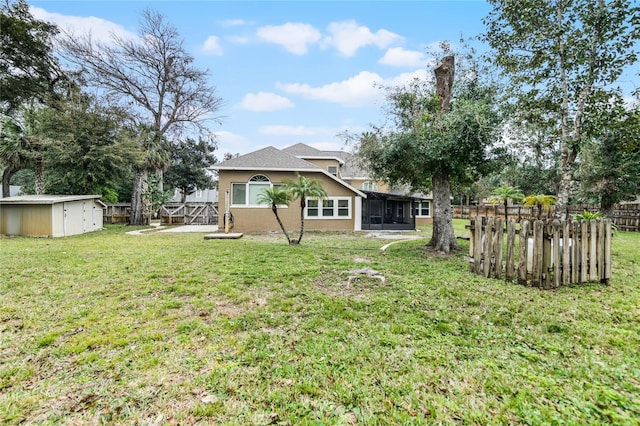 view of yard featuring a shed and a sunroom