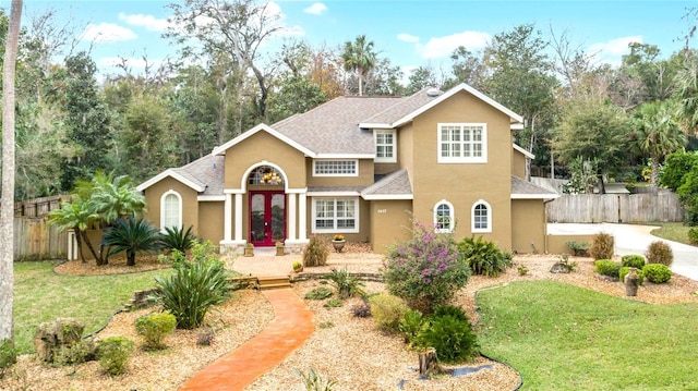 view of front of house with french doors and a front lawn