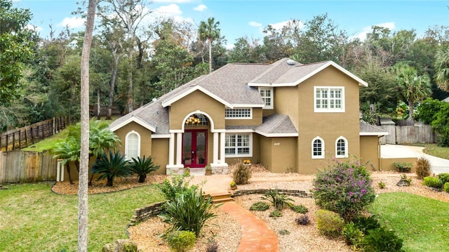 front of property with a front lawn and french doors