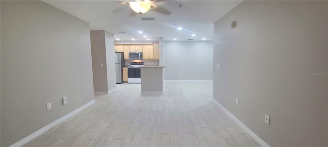 unfurnished living room featuring light hardwood / wood-style flooring and ceiling fan