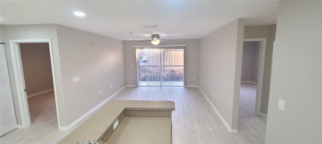 spare room featuring ceiling fan and light wood-type flooring