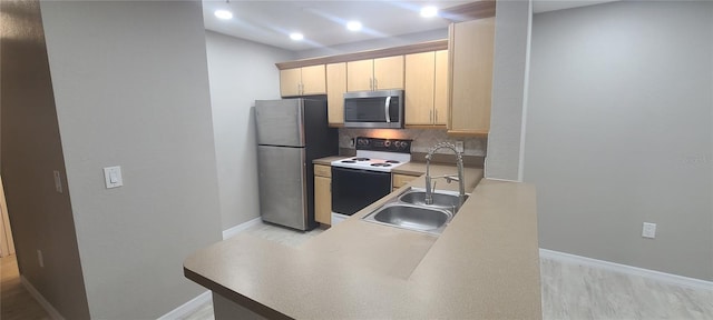 kitchen featuring tasteful backsplash, stainless steel appliances, sink, and light brown cabinets