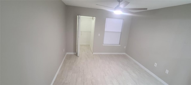 spare room with light hardwood / wood-style flooring and ceiling fan