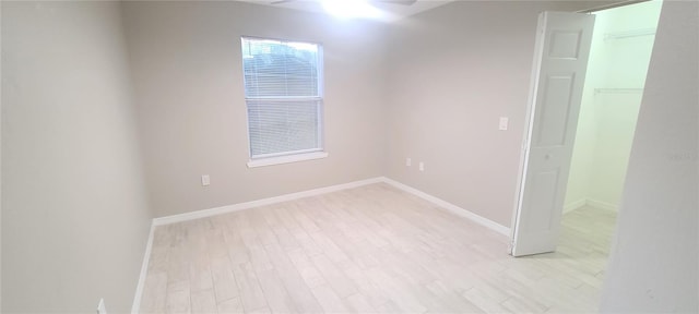 unfurnished room with a healthy amount of sunlight and light wood-type flooring