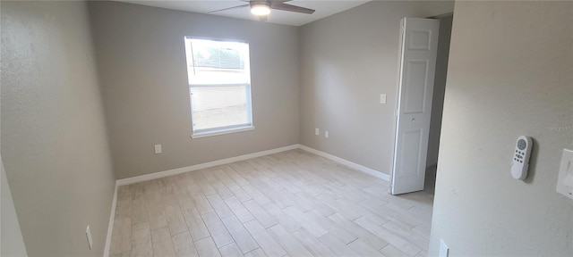 spare room featuring light hardwood / wood-style flooring and ceiling fan