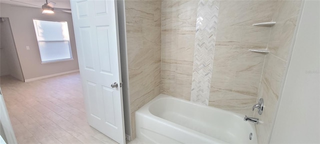 bathroom featuring hardwood / wood-style floors and tiled shower / bath combo