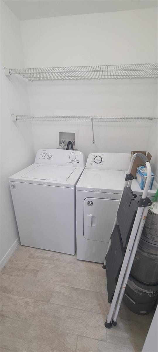 washroom with washing machine and clothes dryer