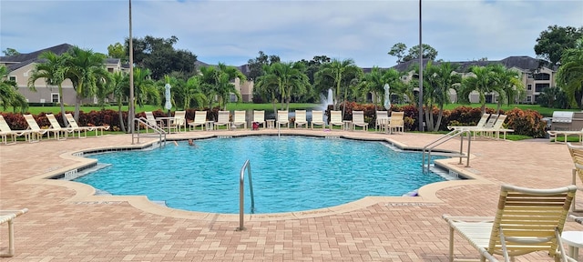 view of pool with a patio and a grill