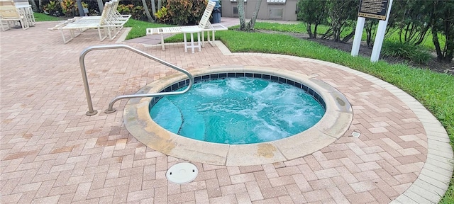 view of pool featuring a hot tub and a patio area