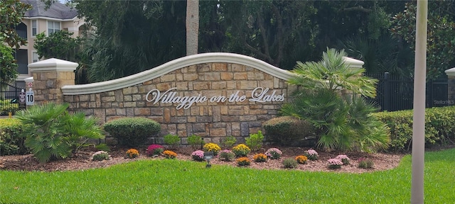 community sign featuring a lawn