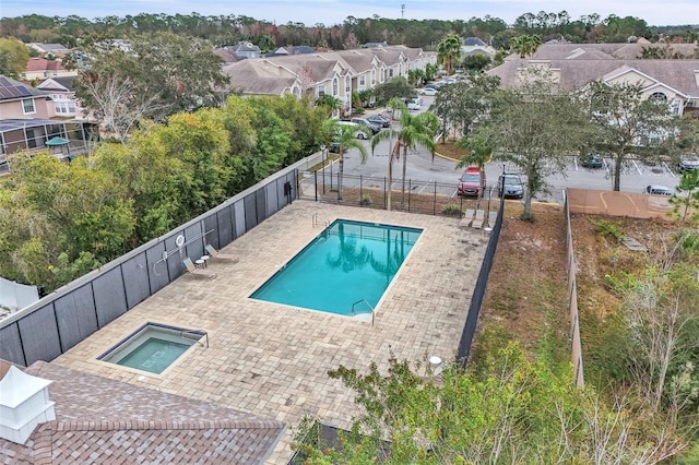 view of pool featuring an in ground hot tub and a patio