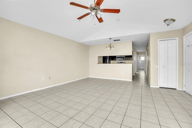 unfurnished living room with light tile patterned floors, lofted ceiling, and ceiling fan with notable chandelier