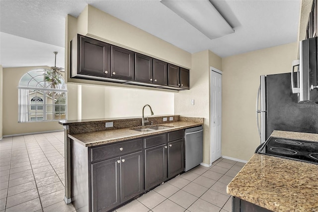 kitchen featuring light tile patterned floors, ceiling fan, stainless steel appliances, dark brown cabinetry, and sink