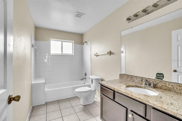 full bathroom featuring toilet, tiled shower / bath, tile patterned flooring, a textured ceiling, and vanity