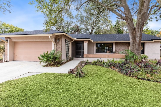 single story home with a garage and a front yard