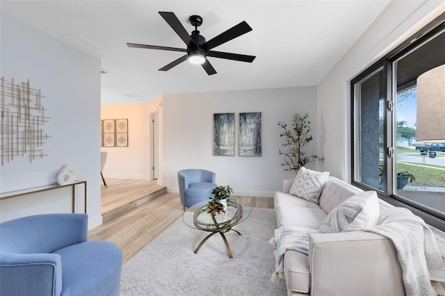 living room featuring ceiling fan and light hardwood / wood-style floors