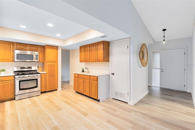 kitchen with stainless steel appliances and light hardwood / wood-style flooring