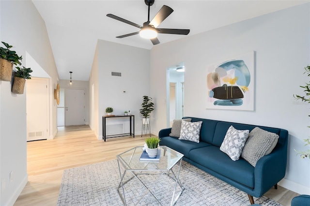 living room with vaulted ceiling, ceiling fan, and hardwood / wood-style flooring