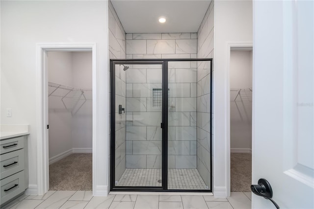 bathroom featuring a stall shower and vanity