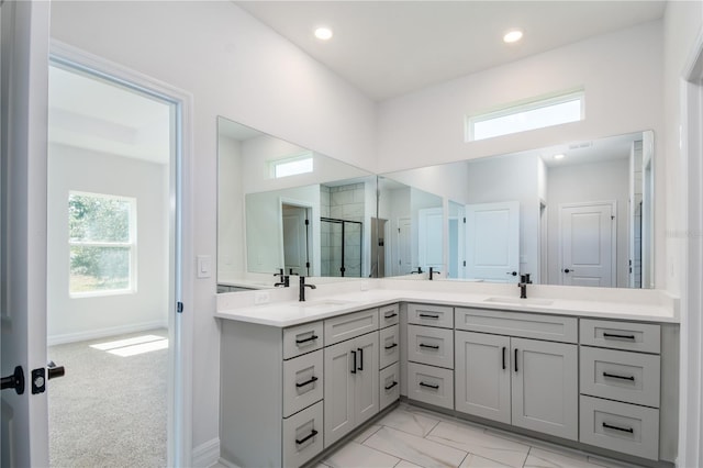 full bathroom featuring recessed lighting, a sink, a shower stall, and double vanity