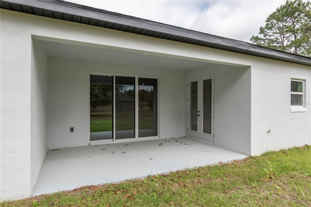 exterior space featuring a patio and stucco siding