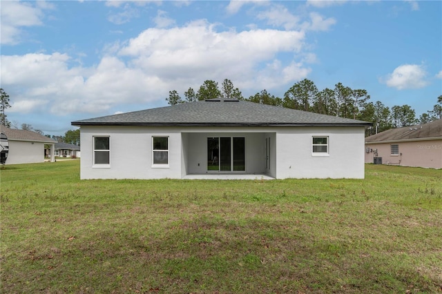 back of property featuring central air condition unit, a patio area, a yard, and stucco siding