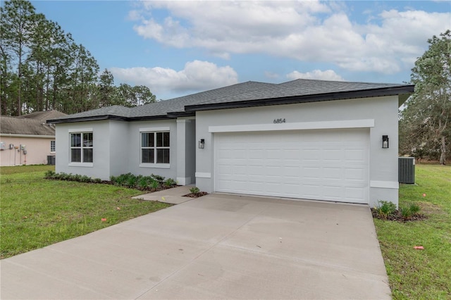 view of front of home with stucco siding, concrete driveway, a garage, cooling unit, and a front lawn