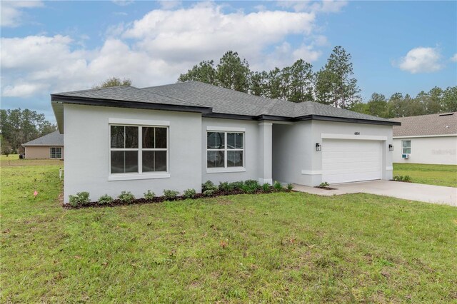 view of front of home with a front lawn, driveway, an attached garage, and stucco siding