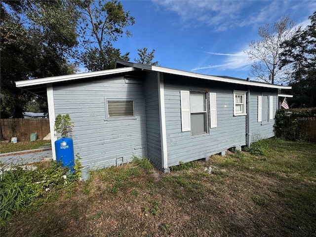 view of side of property with a yard