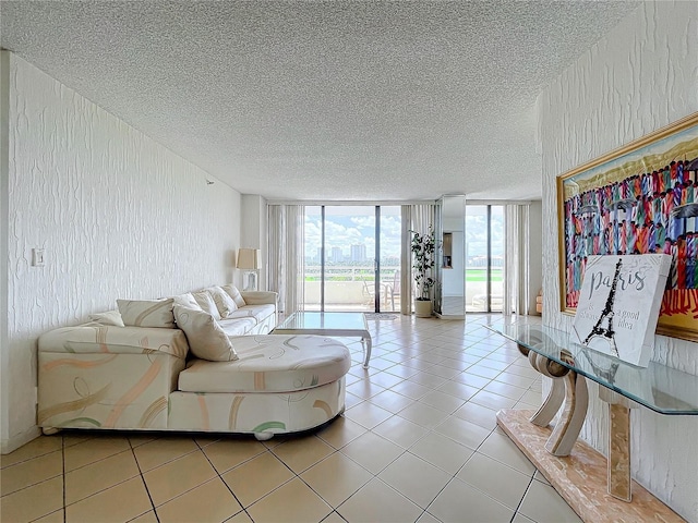 tiled living room with a wall of windows and a textured ceiling