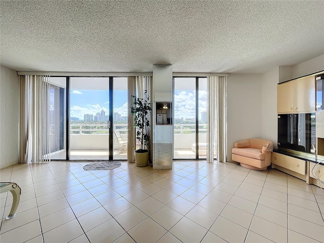 unfurnished living room featuring light tile patterned flooring and expansive windows