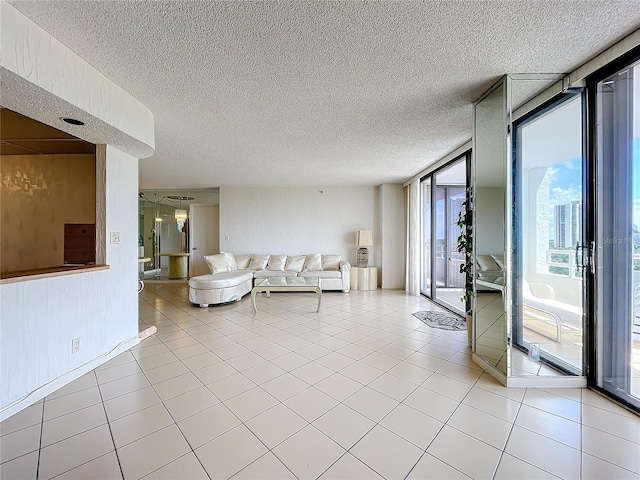 unfurnished living room with light tile patterned flooring and floor to ceiling windows