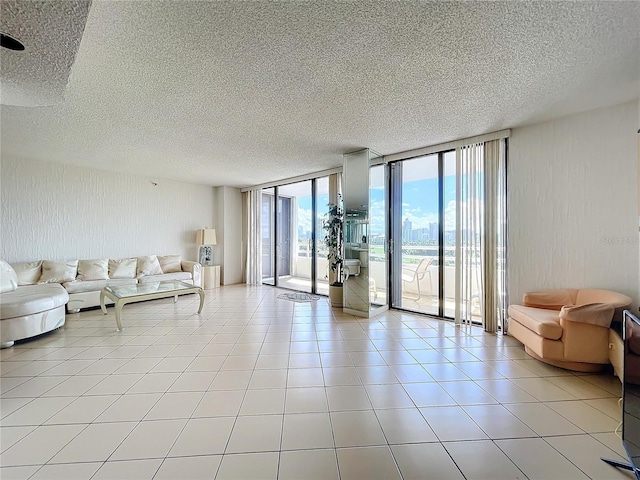 living room featuring expansive windows and light tile patterned floors