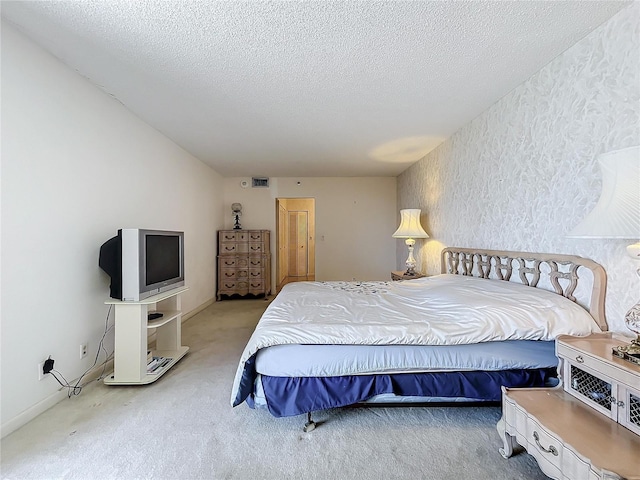 carpeted bedroom featuring a textured ceiling