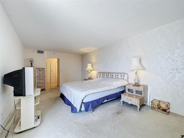 bedroom featuring a textured ceiling and carpet floors